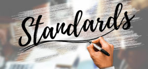 A hand writing the word "Standard"